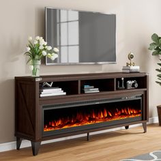 an entertainment center with a fireplace in the middle and a flat screen tv above it