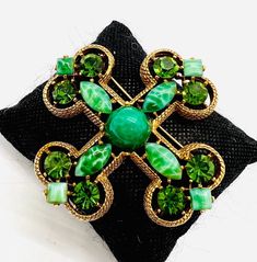 Gorgeous Large Vintage signed CAPRI Peking Glass & Rhinestone Maltese Cross Brooch. Antiqued gold plated metal set with Peking Glass stones as well as green rhinestones. In excellent vintage condition with minimal age appropriate wear. No chips or cracks. Measures 2 7/8 inches tall and wide. Roll over clasp secure. Vintage Green Brooch Jewelry, Elegant Green Jeweled Brooches, Vintage Green Jeweled Jewelry, Antique Green Jeweled Jewelry, Green Jeweled Brooches As Gift, Green Jeweled Brooch For Gift, Victorian Green Collectible Brooches, Green Costume Jewelry Brooch For Collectors, Green Jeweled Brooch Gift