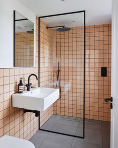 a bathroom with a sink, mirror and shower stall