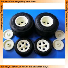 four white wheels and two black tires on a blue background