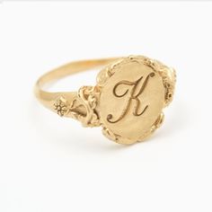 This vintage style signet ring is inspired by 17th-century Italian  Baroque architecture, featuring beautiful little fluorishes all around the center which displays your personal monogram or initials. This ring can be customized with any letter or word (provided it fits) and is made in solid gold. This ring can be made for men or women and in your preferred size or color of gold. A phrase or letter may be written on the inside, too!All designs are modelled and sent to you for approval before cas K Signet Ring, Luxury Vintage Signet Ring With Engraving Option, Ornate Engraved Yellow Gold Ring As Gift, Ornate Yellow Gold Engraved Ring As Gift, Vintage Signet Ring With Engraving Option, Vintage Signet Ring With Intricate Design For Anniversary, Victorian Engraved Signet Promise Ring, Antique Personalized Yellow Gold Signet Ring, Vintage Yellow Gold Engraved Initial Ring