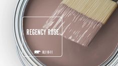 a paint can with a brush in it and the words regenty rose on it