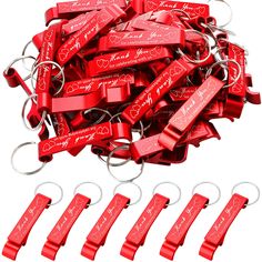 a bunch of red metal key chains with hearts on them