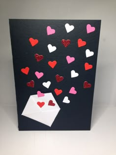 a card with hearts and envelope on it