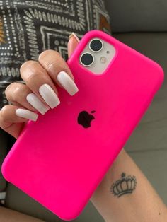 a woman's hand holding a pink iphone case