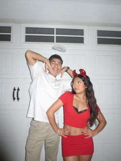 a man and woman posing in front of a garage door with their arms around each other