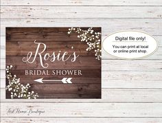 the rustic bridal shower sign is displayed on a wooden background with an arrow pointing to it