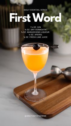 the first word cocktail is served in a coupe glass with an olive garnish