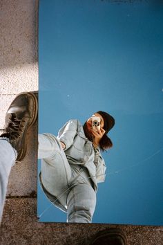 a person standing in front of a mirror on the ground