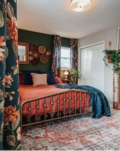 a bed room with a neatly made bed next to a window and a potted plant