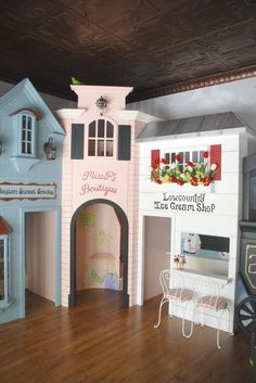 there is a doll house made out of wood and plastic material with furniture inside it