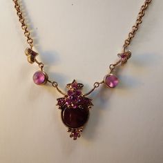 Listing Is For A Victorian Style Necklace With A Purple Centerpiece,And Pink Rhinestones. Measures 16.5 Inches. This Is Not A Brand New Item. It Will May Have Dings And Scratches,But I Do My Best To Point Them Out Please Use Photos And Video So You Can Determine The Condition. Kindly Visit My Closet For Vintage Items, Gems On Silver, Bracelets, And Necklace Sets Made With Swarovski Xirius Crystal On Brass And Gunmetal. Thank You. Purple And Gold Jewelry, Victorian Jewellery Designs, Purple Vintage Jewelry With Intricate Design, Whimsigoth Necklace, Ornate Purple Gemstone Jewelry, Victorian 14k Gold Purple Jewelry, Amethyst Necklaces, Purple Centerpiece, Ornate Purple Gemstone Necklace