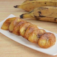 some bananas are sitting on a white plate