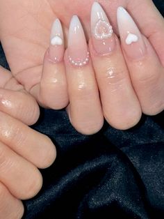 a woman's hands with white and black nail polish