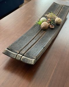 a wooden table with some plants on it and other things sitting on top of it