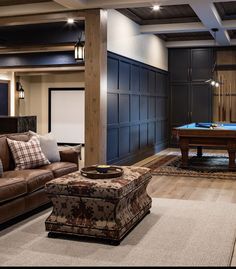 a living room filled with furniture and a pool table