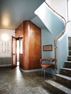 a room with stairs and a chair in it