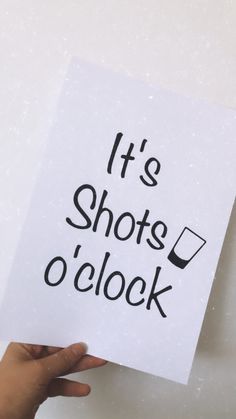 someone holding up a sign that says it's shots o'clock