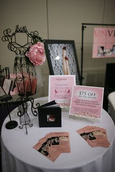 a table topped with pink cards and pictures