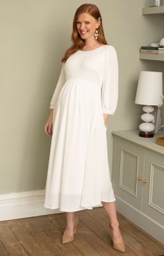 Feel fabulously feminine in our softly tailored and lightweight midi maternity dress in sheen ivory. Featuring a gently sheer pleated jersey, this maternity midi style is your go-to either for understated bridal chic, evening glamour or simply a relaxed vibe. You choose. Designed with a scooped neckline, cuffed sleeves, pleats across the empire line and a swishy skirt with concealed pockets for extra 'cool'. Soft sheen pleated jersey in ivory Scooped neckline front and back Bell sleeves finished Midi Maternity Dress, Maternity Occasion Dress, Rose Tiffany, Tiffany Rose, Pregnant Wedding, Pregnant Wedding Dress, Full Length Gowns, Party Kleidung, Scooped Neckline