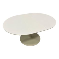 a white table with an oval shaped base