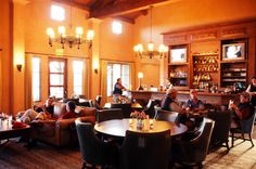 a group of people sitting at tables in a restaurant