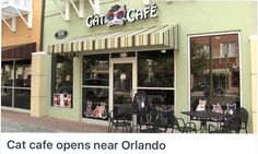 the outside of a cafe with tables and chairs on the sidewalk in front of it