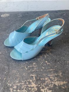 Vintage Amano Light Blue Sandal Heels marked size 7. In great vintage condition - showing some wear throughout. Beautifully Italian made leather heels in a perfect light sky blue color. Approx. Measurements: Heel height: 3 2/3" Length: 7.5 Vintage Formal Sandals With 4-inch Heel, Vintage Heels With Deep Heel Cup For Summer, Formal Light Blue Open Toe Sandals, Blue Open Toe Heels With Wooden Heel, Formal Light Blue Sandals With Padded Heel, Vintage Blue Pointed Toe Heels, Light Blue Leather Sandals For Formal Occasions, Light Blue Open Heel Strap Heels, Light Blue Open Heel Heels With Strap