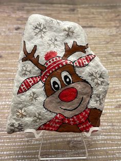 a rock with a reindeer painted on it