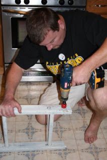 a man is using a drill to fix a hole in the floor with a screwdriver