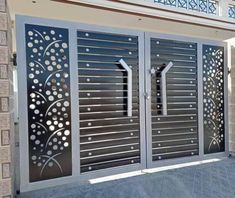 an iron gate with decorative designs on the sides and side panels that are designed to look like flowers