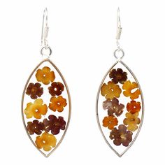 Featuring real dried flowers, these translucent earrings offer a one-of-a-kind beauty to each piece. Grown in the fields of the Taxco region in Mexico, these miniature flowers are gathered by hand and preserved permanently in resin surrounded in an Alpaca silver setting by women artisans in Mexico. The natural properties of real flowers provides a one-of-a-kind look to each piece. Earrings measure 2.25-inches long by .75-inch wide. Sterling silver hooks. Flowers are dried and then forever preser Artisan Gifts, Heart Quilts, Flowers In Resin, Vhc Brands, Artisan Gift, Heart Quilt, Country Store, Resin Flowers, Tiny Flowers