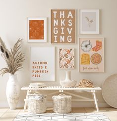 a white table topped with lots of pictures next to a vase filled with flowers and plants