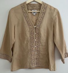 Women's vintage Laura Ashley button up blouse in tan colour Linen Cotton embroidery around edges Size 8 or small in excellent vintage condition Beige Linen Tops With Floral Embroidery, Beige Button-up Blouse With Floral Embroidery, Beige Embroidered Button-up Top, Embroidered Beige Linen Top, Beige Embroidered Linen Top, Vintage Beige Linen Blouse, Vintage Embroidered Beige Tops, Linen Button-up Top With Embroidery, Linen Embroidered Button-up Top