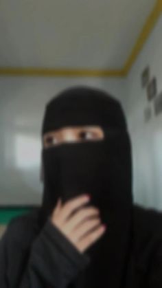 a woman wearing a black burka covering her face