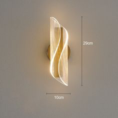 the wall light is designed to look like an abstract piece of art with wavy lines on it