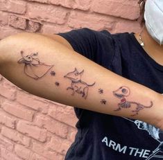 a woman with a tattoo on her arm that has pictures of animals and stars all over it