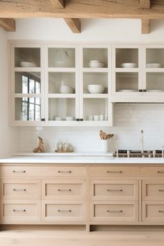 a kitchen with wooden cabinets and white counter tops