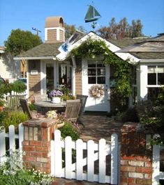 a white picket fence in front of a house