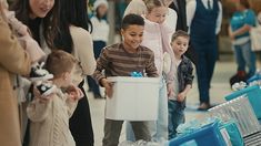 a group of people standing next to each other in front of blue and white boxes