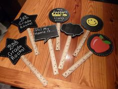 there are many chalkboard stick decorations on the table