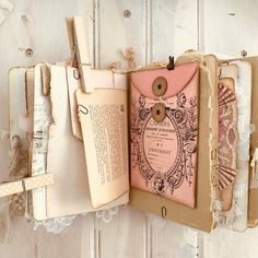 an open book with some tags attached to it's cover and lace around the edges