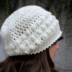 a woman wearing a white knitted hat