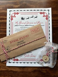 an envelope is wrapped in brown paper and tied with twine, on top of a wooden table