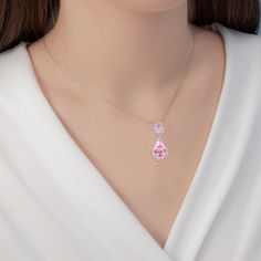 Lavencious is proud to present its exquisite Teardrop Dangle with AAA Pink Cubic Zirconia Necklace & Earrings Set. This hand-crafted set is made with brilliance and care, featuring high-grade AAA pink cubic zirconia stones, making it a luxurious addition to any jewelry collection. The necklace and earrings feature a classic teardrop silhouette, ensuring timeless elegance. - Necklace is 16" x 3" length,pendant and earrings are the same size : 1.18" x 1.18" - Rhodium Plated to enhance shine and du Fine Jewelry Pink Teardrop Pendant, Pink Teardrop Pendant Fine Jewelry, Pink Cubic Zirconia Teardrop Jewelry, Pink Crystal Jewelry For Mother's Day, Pink Teardrop Cubic Zirconia Jewelry, Pear-shaped Sparkling Stone Necklaces For Gifts, Pear-shaped Necklaces With Sparkling Stones As Gift, Dazzling Crystal Teardrop Pendant Jewelry, Pink Crystal Jewelry Sets For Anniversary