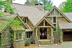 a stone and wood house in the woods