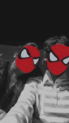 two people with masks covering their faces in the shape of spider - man and woman