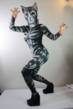 a person in a cat costume standing on one leg