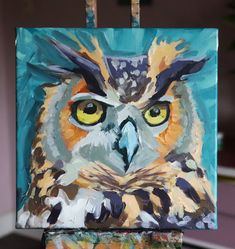 an owl painting is shown on a easel