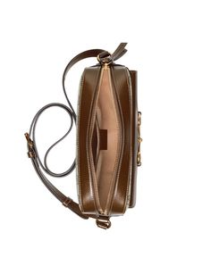 Brown and ebony Horsebit 1955 crossbody bag with adjustable shoulder strap, gold hardware, stitching detail in the same color, front flap pocket, signature horsebit buckle detail, G-top zipper, fully lined, built-in zippered pocket, and built-in logo applique. (This item is packaged in a dust bag or box) Luxury Crossbody Shoulder Bag With Horsebit Detail, Classic Crossbody Shoulder Bag With Horsebit Detail, Luxury Coated Canvas Shoulder Bag With Metal Hardware, Luxury Saddle Bag With Brass Hardware, Luxury Saddle Bag With Brass Hardware Crossbody, Luxury Saddle Bag With Brass Hardware For Travel, Luxury Travel Saddle Bag With Brass Hardware, Gucci Horsebit, Gold Ounce